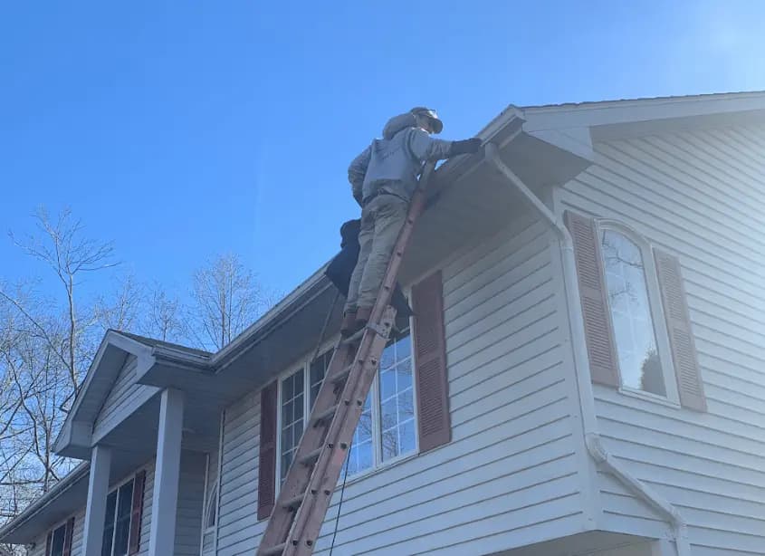 Gutter cleaning and maintenance being performed by North Ridgeville Power Washing in North Ridgeville